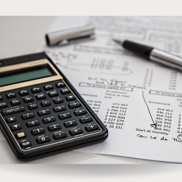 Calculator and and fiscal documents that shows the importance of Tax and Accounting