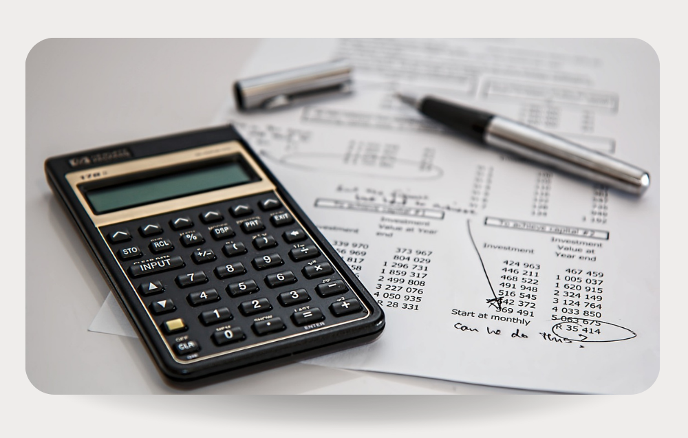 Calculator and and fiscal documents that shows the importance of Tax and Accounting